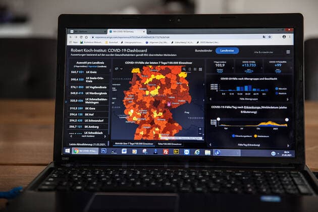 Bamberg, Germany 21 March 2021 On a table in an apartment is an open laptop, on the screen is the page from the Robert Koch Institute with the current COVID 19 case numbers Bayern to see. Copyright: xFotostandx xK.xSchmittx