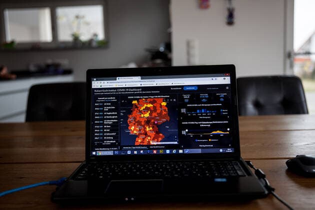 Bamberg, Germany 21 March 2021 On a table in an apartment is an open laptop, on the screen is the page from the Robert Koch Institute with the current COVID 19 case numbers Bayern to see. Copyright: xFotostandx xK.xSchmittx