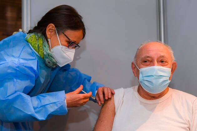A man receives a vaccin shot after the opening of a new vaccination center in Anderlecht, in the Lotto Arena (RSCA stadium), Monday 22 March 2021.  LAURIExDIEFFEMBACQ 2677095