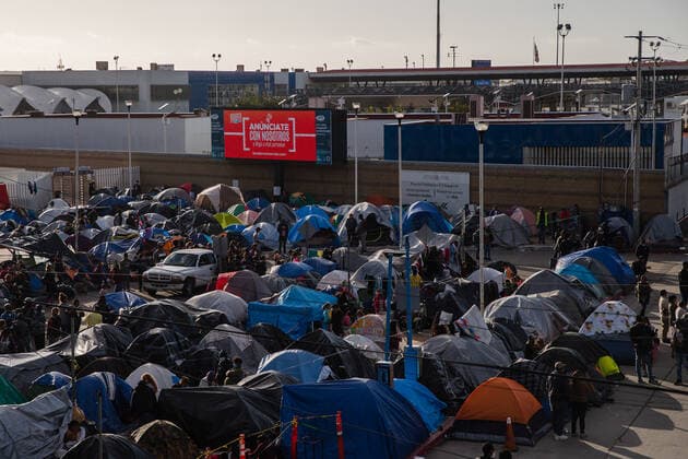 Hundreds of asylum seekers have set up tents near the El Chaparral port of entry in Tijuana, Mexico in hopes of being able to seek asylum in the United States, on Sunday, March 21, 2021. Biden has pledged to take new steps to address the surge of migrants on the border since he took office.  TIJ2021032109 ARIANAxDREHSLER