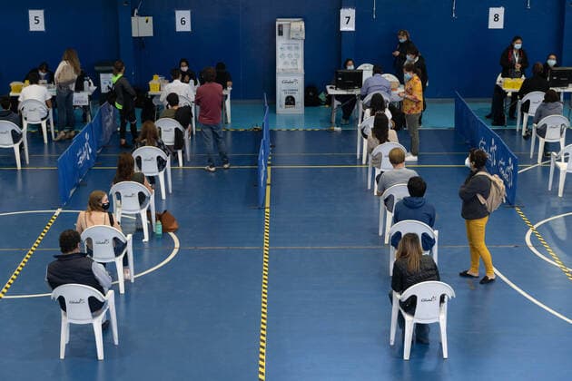 March 22, 2021, Santiago, Metropolitana, Chile: People wait to receive the dose of the Sinovac or Pfizer vaccine, in a municipal stadium transformed into a vaccination center against covid in Santiago, Chile. Santiago Chile - ZUMAb332 20210322_zip_b332_004 Copyright: xMatiasxBasualdox