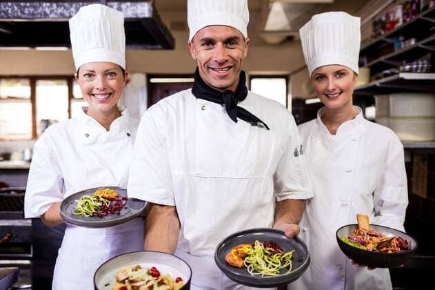 Group of chefs holding plate of prepared food in kitchen Group of chefs holding plate of prepared food in kitchen at hotel, model released, , property released, Cork, Ireland, 04.01.2019, 1210114.jpg, chef, occupation, professional, profession, skill, expertise, job, trainee, catering, coworker, staff, chefs white, chefs hat, chefs scarf, uniform, team, teamwork, together, beautiful, pretty, standing, smiling, happy, cheerful, holding, plate, food, tasty, delicious, indulgence, gourmet, freshness, hotel, restaurant, kitchen, commercial, hospitality, service, business, retail, food and drink industry 40s, Mature Adult, Man, Male, Caucasian, 30s, Mid Adult, Woman, Female, 40-44 Years, Mature Men, Caucasian Ethnicity, 30-34 Years, Mid Adult W