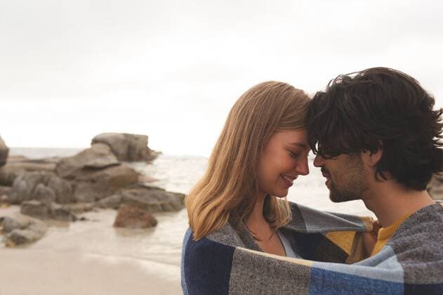 Caucasian couple wrapped in blanket standing at beach Side view of young Caucasian couple wrapped in blanket kissing each other standing at beach, model released, Cork, Ireland, 05.02.2019, 1239047.jpg, couple, relationship, handsome, smart, beautiful, gen z, generation z, casual clothing, standing, relaxing, wrapped, wrapped in blanket, arm around, head to head, cloud, sea, ocean, shore, wave, nature, environment, tranquility, scenic, travel, travel destination, tourism, holiday, vacation, sunny, summer, together, bonding, love, care, closeness, trust, romance, romantic Outdoors,Side view,Head and shoulders