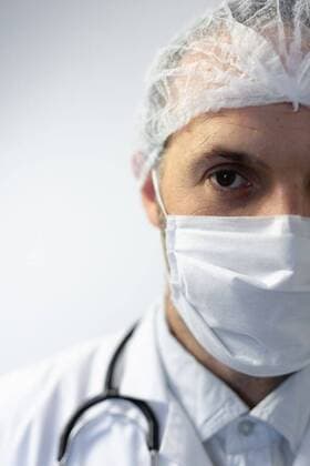 Healthcare worker during coronavirus covid19 pandemic Portrait of a Caucasian man, wearing doctor uniform and a stethoscope on his shoulders, wearing a face mask and standing in an empty white room, looking at camera, model released, , property released, Cape Town, South Africa, 09.04.2020, 1343721.jpg, people,real people,social distancing,quarantine,self isolation,isolation,distance,lock down,coronavirus,covid19,corona,virus,covid 19,covid-19,pandemic,epidemic,health scare,fear,protection,global,outbreak,contagious,contagion,face mask,warning,filter,health hazard,infection,mask,safety,unhealthy,scare,environment,doctor,uniform,medicine,portrait,medical,profession,professional,healthcare,job,work,worker,career,health,hospital,lab coat,stet