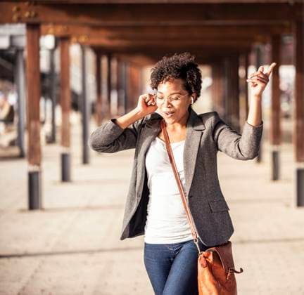 Young woman dancing while listening music on footpath model released Symbolfoto UUF23069