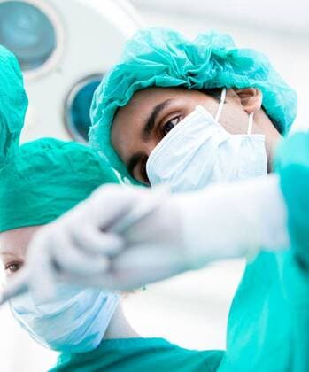 Serious surgeons during an operation. Medical concept. Serious surgeons during an operation. Medical concept., model released, Cape Town, South Africa, 2009-10-01T23:00:00.000Z, 22616.jpg, surgeon, doctor, hospital, surgery, medical, healthcare, clinic, health, nurse, operation, care, mask, professional, surgical, operating, medicine, operate, uniform, disease, physician, emergency, sterile, specialist, procedure, treatment, examine, team, work, clinical, more, assistant, medicare, recovery, practice, staff, personnel, patient 20s, Young Adult, Woman, Female, Caucasian, Man, Male, Asian, 30s, Mid Adult, Caucasian Appearance, 25-29 Years, Young Women, Asian ethnicity, Young Men, 30-34 Years, Mid Adult Men