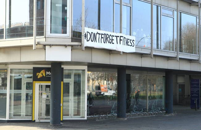 On the facade of a studio of the chain McFit, closed because of the lockdown, a poster with a call for help is attached Borgfelde Hamburg