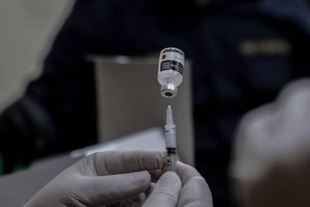 March 25, 2021, Depok, Jawa Barat, Indonesia: A vial with a dose of Sinovac COVID-19 vaccine seen with a syringe during a mass vaccination drive for the public sector workers at Geospatial Information Agency Office in Bogor..Indonesia is currently in the second phase of mass covid-19 vaccination. In this second phase, the Indonesian government targets 38.5 million people, including 16.9 million workers in public sectors and 21.6 million elderly citizens, as well as workers in hospitality, transportation, tourism sectors and mass media workers. Depok Indonesia - ZUMAs197 20210325_zaa_s197_085 Copyright: xRisaxKrisadhix