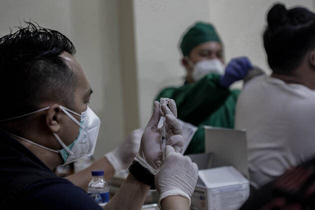 March 25, 2021, Depok, Jawa Barat, Indonesia: A healthcare worker preparing a dose of Sinovac COVID-19 vaccine during a mass vaccination drive for the public sector workers at Geospatial Information Agency Office in Bogor..Indonesia is currently in the second phase of mass covid-19 vaccination. In this second phase, the Indonesian government targets 38.5 million people, including 16.9 million workers in public sectors and 21.6 million elderly citizens, as well as workers in hospitality, transportation, tourism sectors and mass media workers. Depok Indonesia - ZUMAs197 20210325_zaa_s197_087 Copyright: xRisaxKrisadhix