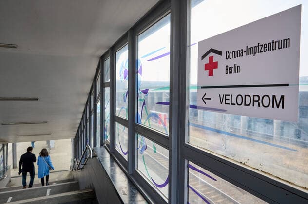 Signpost to the Corona vaccination centre in the Berlin Velodrom at S-Bahn station Landsberger Allee in Berlin Signpost to the Corona vaccination centre in the Berlin Velodrom at Landsberger Allee S Bahn station in Berlin snapshot photography F Boillot
