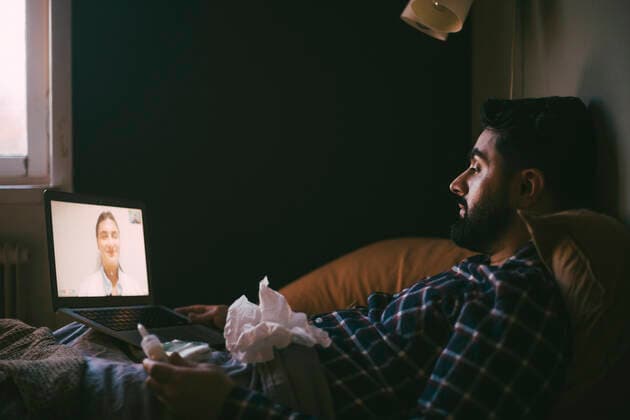 Man taking advice through online consultation on video call with doctor at home Sweden, Stockholm, model released, property released Copyright: xMaskotx , MA85605