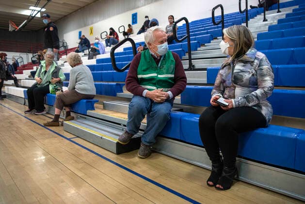 March 26, 2021, USA: Dr. John Ogren, the regional health officer for the New Mexico Department of Health, talks with New Mexico Governor Michelle Lujan Grisham after she received her Pfizer COVID-19 vaccine during a vaccination event held in the gym at Desert Sage Academy in Santa Fe, Friday March 26, 2021. USA - ZUMAab1_ 20210326_zaf_ab1_008 Copyright: xEddiexMoorex