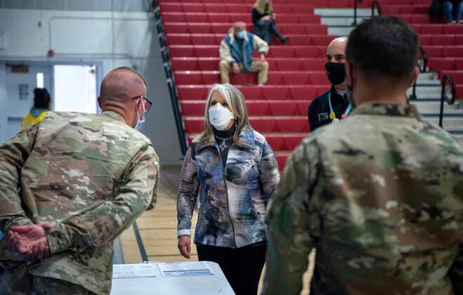 March 26, 2021, USA: New Mexico Governor Michelle Lujan Grisham talks with National Guardsmen after receiving her Pfizer COVID-19 vaccine during a vaccination event held in the gym at Desert Sage Academy in Santa Fe, Friday March 26, 2021. USA - ZUMAab1_ 20210326_zaf_ab1_009 Copyright: xEddiexMoorex