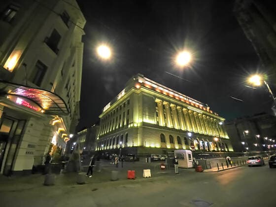 Old town with restaurants and bars with tourists, National Bank of Romania and local people in Bucharest, Romania on March 27, 2021.