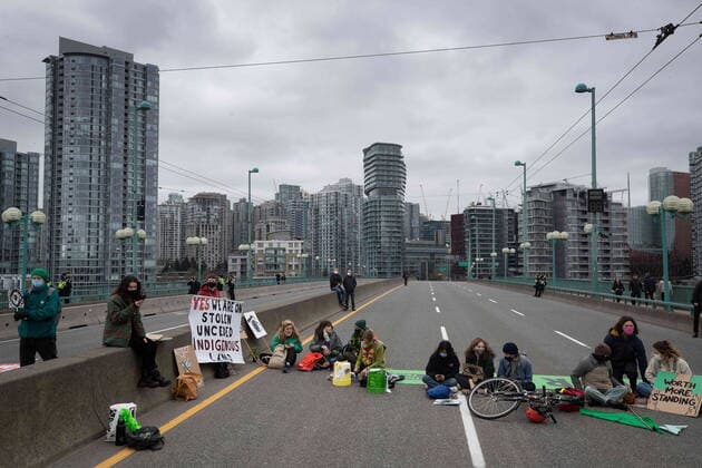 March 27, 2021, Vancouver, BC, Canada: People taking part in an Extinction Rebellion protest against old-growth logging sit on the Cambie Bridge, in Vancouver, B.C., Saturday, March 27, 2021. Vancouver Canada  - ZUMAc35_ 20210327_zaf_c35_052 Copyright: xDarrylxDyckx