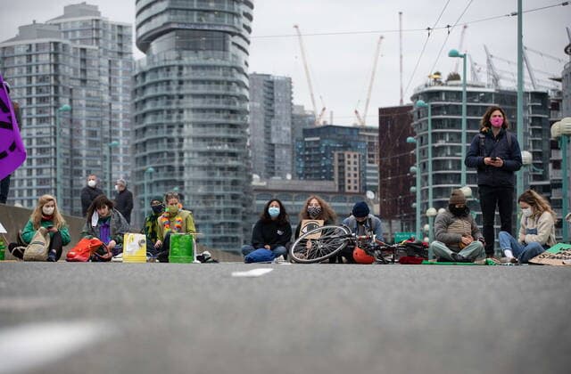 March 27, 2021, Vancouver, BC, Canada: People taking part in an Extinction Rebellion protest against old-growth logging sit on the Cambie Bridge, in Vancouver, B.C., Saturday, March 27, 2021. Vancouver Canada  - ZUMAc35_ 20210327_zaf_c35_053 Copyright: xDarrylxDyckx