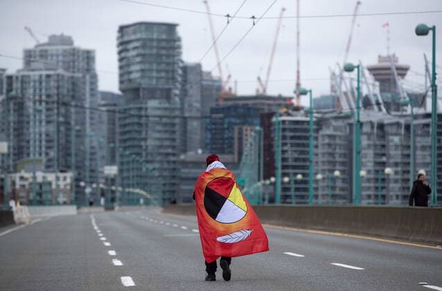 March 27, 2021, Vancouver, BC, Canada: A person taking part in an Extinction Rebellion protest against old-growth logging marches onto the empty Cambie Bridge, in Vancouver, B.C., Saturday, March 27, 2021. Vancouver Canada  - ZUMAc35_ 20210327_zaf_c35_055 Copyright: xDarrylxDyckx