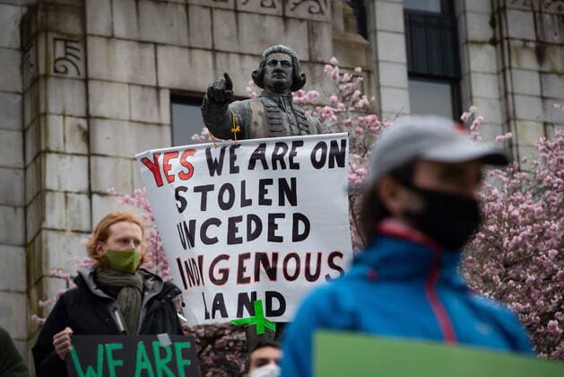 March 27, 2021, Vancouver, BC, Canada: A sign is hung from the arm of a statue of Captain George Vancouver outside city hall as people taking part in an Extinction Rebellion protest against old-growth logging listen to speeches, in Vancouver, B.C., Saturday, March 27, 2021. The group of protesters marched onto the Cambie Bridge forcing the closure of all lanes of traffic into and out of downtown. Vancouver Canada  - ZUMAc35_ 20210327_zaf_c35_056 Copyright: xDarrylxDyckx