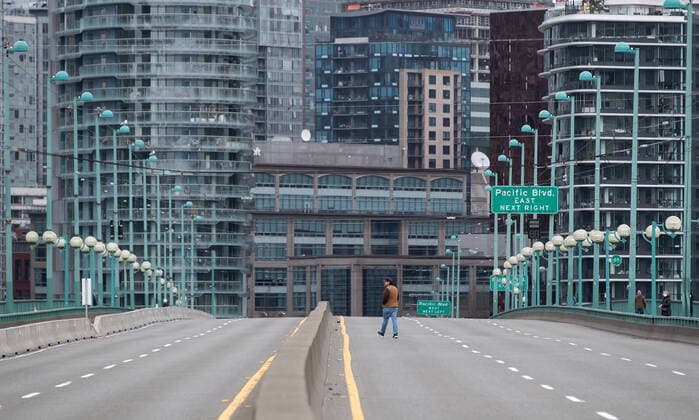 March 27, 2021, Vancouver, BC, Canada: A person walks on the empty Cambie Bridge which was closed to vehicles after people taking part in an Extinction Rebellion protest against old-growth logging marched onto the bridge and occupied it, in Vancouver, B.C., Saturday, March 27, 2021. Vancouver Canada  - ZUMAc35_ 20210327_zaf_c35_063 Copyright: xDarrylxDyckx