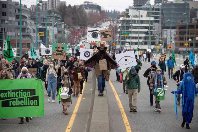 March 27, 2021, Vancouver, BC, Canada: People taking part in an Extinction Rebellion protest against old-growth logging march onto the empty Cambie Bridge, in Vancouver, B.C., Saturday, March 27, 2021. Vancouver Canada  - ZUMAc35_ 20210327_zaf_c35_062 Copyright: xDarrylxDyckx