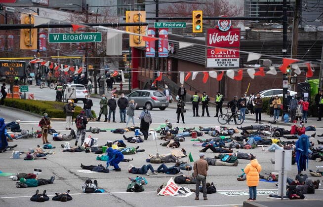 March 27, 2021, Vancouver, BC, Canada: People taking part in an Extinction Rebellion protest against old-growth logging lie on the street, in Vancouver, B.C., Saturday, March 27, 2021. The group of protesters marched onto the Cambie Bridge forcing the closure of all lanes of traffic into and out of downtown. Vancouver Canada  - ZUMAc35_ 20210327_zaf_c35_065 Copyright: xDarrylxDyckx