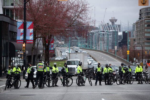 March 27, 2021, Vancouver, BC, Canada: Police officers block traffic as people taking part in an Extinction Rebellion protest against old-growth logging prepare to march onto the Cambie Bridge behind them, in Vancouver, B.C., Saturday, March 27, 2021. Vancouver Canada  - ZUMAc35_ 20210327_zaf_c35_066 Copyright: xDarrylxDyckx