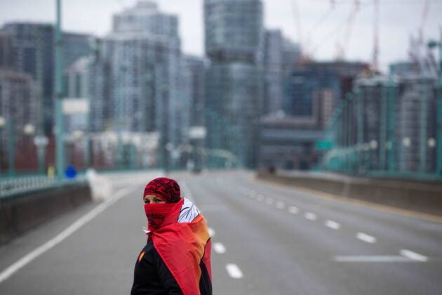 March 27, 2021, Vancouver, BC, Canada: A person taking part in an Extinction Rebellion protest against old-growth logging marches onto the empty Cambie Bridge, in Vancouver, B.C., Saturday, March 27, 2021. Vancouver Canada  - ZUMAc35_ 20210327_zaf_c35_069 Copyright: xDarrylxDyckx