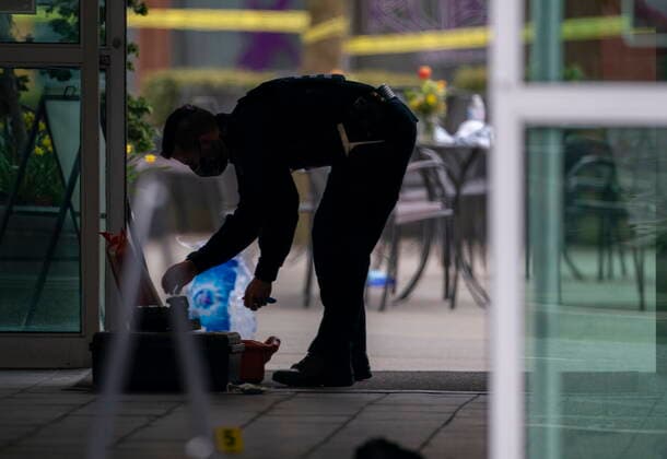 March 27, 2021, Vancouver, BC, Canada: A member of the RCMP is silhouetted as he investigates the scene at the Lynn Valley Library, in North Vancouver, B.C., Saturday, March 27, 2021. Police say multiple victims were stabbed inside and outside the library today. THE CANADIAN PRESS Vancouver Canada  - ZUMAc35_ 20210327_zaf_c35_070 Copyright: xJonathanxHaywardx
