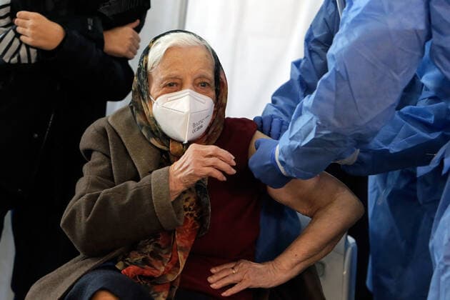 (210328) -- BUCHAREST, March 28, 2021 -- Zoea Baltag, 105-year-old, receives the second shot of COVID-19 vaccine at a hospital in Bucharest, Romania, March 28, 2021. (Photo by Xinhua) ROMANIA-BUCHAREST-COVID-19-VACCINATION CristianxCristel 