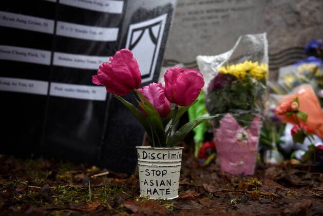 March 28, 2021, Ottawa, on, Canada: Flowers are laid at the foot of the Ottawa Women s Monument in Minto Park as people gather for a vigil in memory of the victims of the Atlanta spa shootings and to rally against anti-Asian racism, in Ottawa, on Sunday, March 28, 2021. Ottawa Canada  - ZUMAc35_ 20210328_zaf_c35_068 Copyright: xJustinxTangx