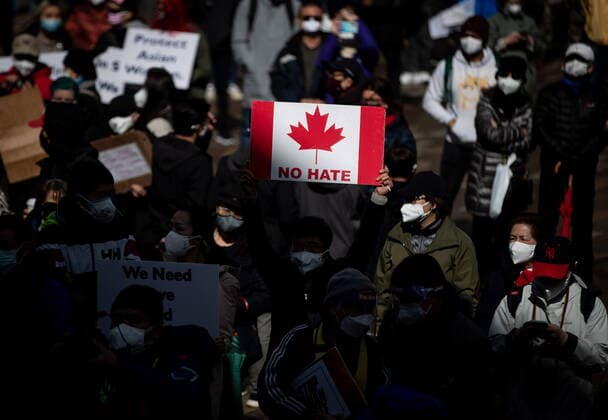 March 28, 2021, Vancouver, BC, Canada: A person holds a Canadian flag sign with the words No Hate on it during a rally opposing discrimination against Asian communities and to mourn the victims of those affected by the Atlanta shootings, in Vancouver, B.C., on Sunday, March 28, 2021. Vancouver Canada  - ZUMAc35_ 20210328_zaf_c35_135 Copyright: xDarrylxDyckx