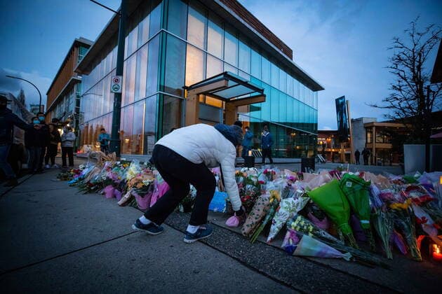 March 28, 2021, Vancouver, BC, Canada: A person places flowers at a memorial outside the Lynn Valley Library for the victims of a mass stabbing incident that happened Saturday inside and around the library, in North Vancouver, B.C., on Sunday, March 28, 2021. A 28-year-old man was charged Sunday with second-degree murder in a stabbing rampage that left a young woman dead and injured six others around a library in North Vancouver on Saturday. Vancouver Canada  - ZUMAc35_ 20210328_zaf_c35_154 Copyright: xDarrylxDyckx