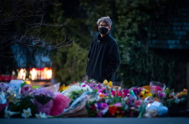 March 28, 2021, Vancouver, BC, Canada: A person pauses at a memorial outside the Lynn Valley Library for the victims of a mass stabbing incident that happened Saturday inside and around the library, in North Vancouver, B.C., on Sunday, March 28, 2021. A 28-year-old man was charged Sunday with second-degree murder in a stabbing rampage that left a young woman dead and injured six others around a library in North Vancouver on Saturday. Vancouver Canada  - ZUMAc35_ 20210328_zaf_c35_160 Copyright: xDarrylxDyckx