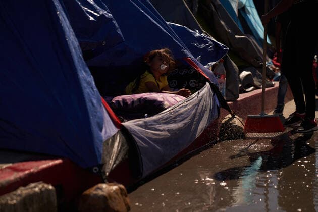 March 28, 2021, Tijuana, Mexico: A child is seen peeking out of her familyÃ¢â‚¬â ¢s tent. Migrants from Central America are stuck living in tents on the street in Tijuana, Mexico on the border while they wait for President Joe Biden to open the American border. Tijuana Mexico - ZUMAd211 20210328_zap_d211_002 Copyright: xAllisonxDinnerx