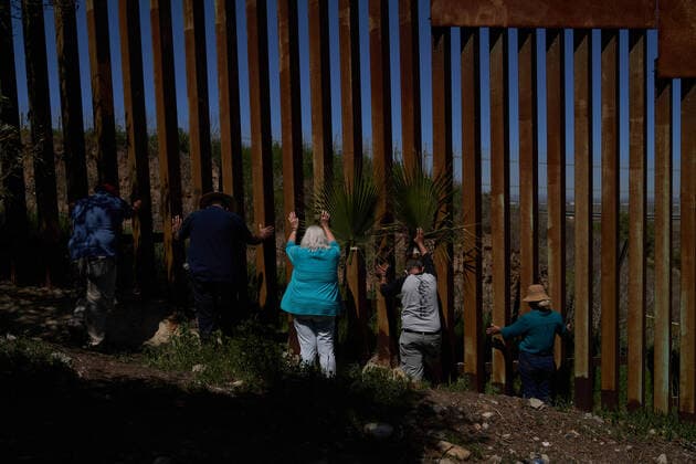 March 28, 2021, Tijuana, Mexico: Pasteur Guillermo Navarrete and volunteers pray at the border wall for migrnats. Pasteur Guillermo Navarrete held a special Palm Sunday mass for the start of Holy Week at a section of the border wall that he has found access to. Normally migrants are in attendance, but due to COVID-19 the mass was live streamed on Facebook and Zoom for migrants to tune in. Tijuana Mexico - ZUMAd211 20210328_zap_d211_029 Copyright: xAllisonxDinnerx