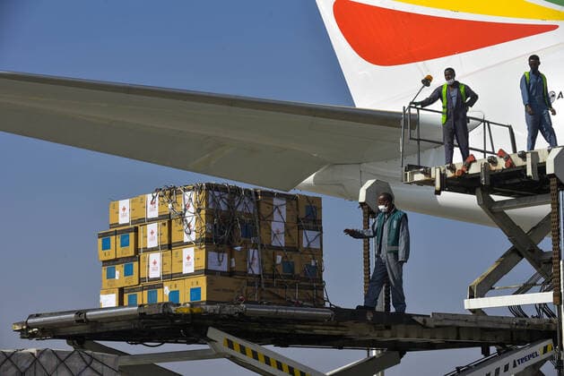 (210330) -- ADDIS ABABA, March 30, 2021 -- Workers unload China s Sinopharm COVID-19 vaccines, donated by the Chinese government to Ethiopia, at the Addis Ababa Bole International Airport in Addis Ababa, Ethiopia, on March 30, 2021. (Photo by Xinhua) ETHIOPIA-ADDIS ABABA-COVID-19-VACCINE-CHINA-DONATION MichaelxTewelde 