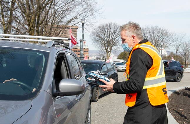 March 30, 2021, QUEBEC, PQ, Canada: An SCFP union worker collects shoes from a member in front of the National Assembly as demonstrators drive around in their cars, Tuesday, March 30, 2021 in Quebec City. Union workers claim negotiations are at a standstill and give it as the reason to drop shoes. QUEBEC Canada  - ZUMAc35_ 20210330_zaf_c35_031 Copyright: xJacquesxBoissinotx