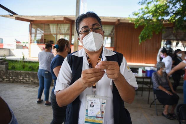March 30, 2021, Tuzamapan, Veracruz, Mo xico: The musical group Los super Caracoles plays their songs while older adults wait in line to be vaccinated against Covid-19. Some older adults joined the dance and celebration to receive the vaccine Tuzamapan MÃ xico - ZUMAqp1_ 20210330_zip_qp1_004 Copyright: xHectorxAdolfoxQuintanarxPerezx