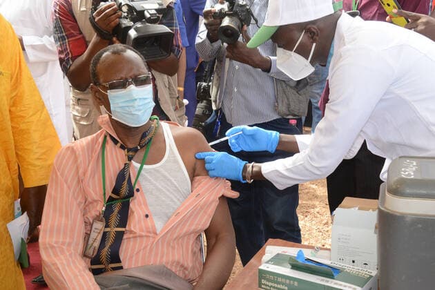 (210331) -- BAMAKO, March 31, 2021 -- A man receives the COVID-19 vaccine in Bamako, Mali, on March 31, 2021. Malian Minister of Health and Social Development Fanta Siby received Wednesday her first dose of COVID-19 vaccine, which symbolized the official kickoff of Mali s COVID-19 vaccination campaign. During this first phase of the vaccination campaign, according to the minister, a total of 21,406 health workers will be vaccinated in Bamako, epicenter of the pandemic in this West African country. (Photo by Xinhua) MALI-BAMAKO-COVID-19-VACCINATION HabibxKouyate