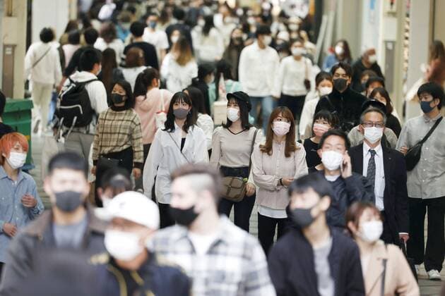 Scene of Osaka amid coronavirus pandemic People wearing face masks walk in Osaka s Minami area on April 2, 2021, amid a resurgence in coronavirus infections in the western Japan prefecture. 