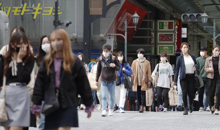 Scene of Osaka amid coronavirus pandemic People wearing face masks walk in Osaka s Minami area on April 2, 2021, amid a resurgence in coronavirus infections in the western Japan prefecture. 