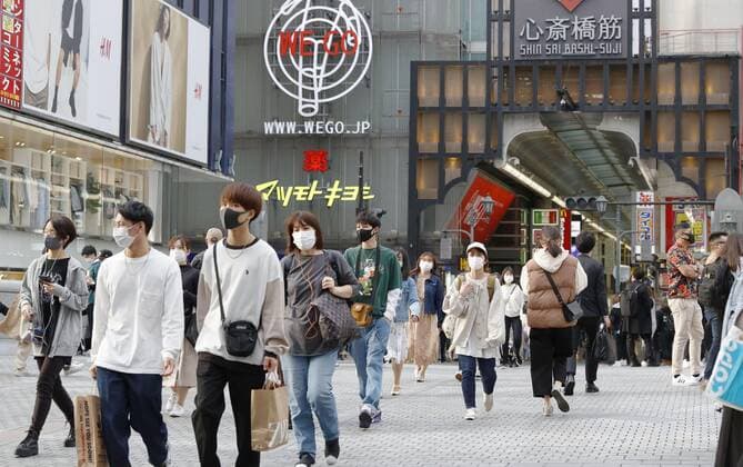 Scene of Osaka amid coronavirus pandemic People wearing face masks walk in Osaka s Minami area on April 2, 2021, amid a resurgence in coronavirus infections in the western Japan prefecture. 