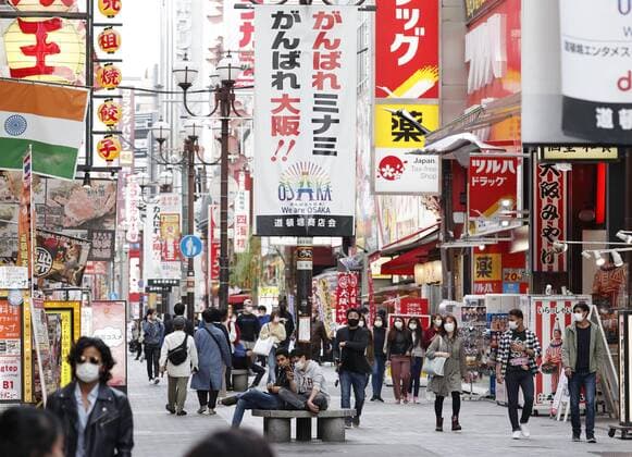 Scene of Osaka amid coronavirus pandemic People wearing face masks walk in Osaka s Minami area on April 2, 2021, amid a resurgence in coronavirus infections in the western Japan prefecture. 