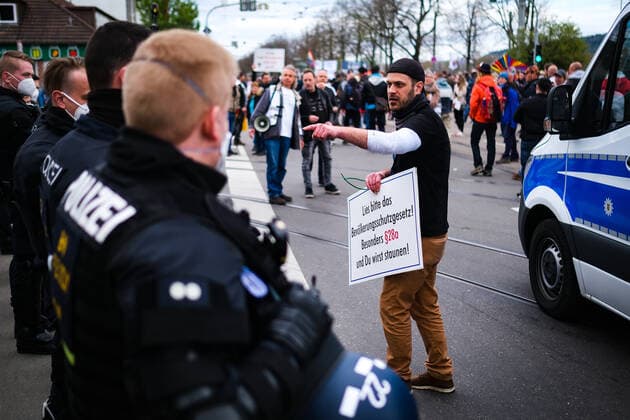 Demonstration against Corona requirements in Stuttgart 03 04 2021 Stuttgart Participants at a rally against Corona requirements at the Cannstatter Wasen in Stuttgart discuss with police Kassel Hesse Germany