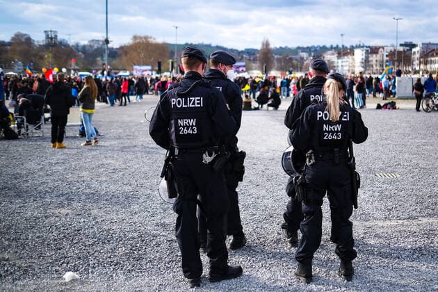 Demonstration against Corona requirements in Stuttgart 03 04 2021 Stuttgart Participants at a rally against Corona requirements at the Cannstatter Wasen in Stuttgart Police officers watch the scene Kassel Hesse Germany