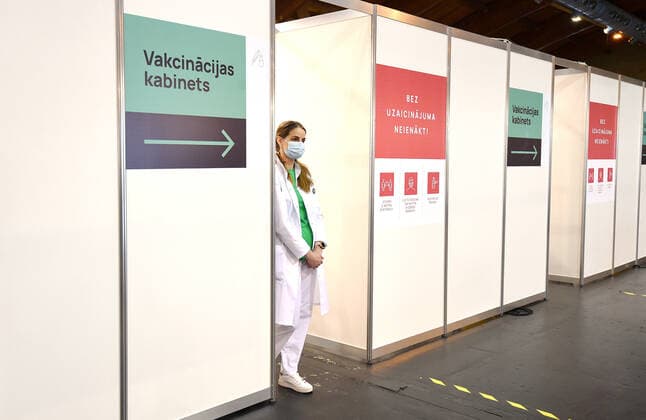 (210403) -- RIGA, April 3, 2021 -- A healthcare worker waits for visitors at a mass immunization center in Riga, Latvia, on April 3, 2021. Latvia on Saturday opened mass immunization centers in eight cities and towns in a bid to ramp up vaccinations against COVID-19, health authorities informed. (Photo by Xinhua) LATVIA-RIGA-COVID-19-MASS IMMUNIZATION CENTER-OPENING EdijsxPalens 