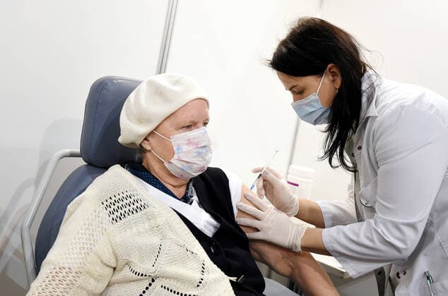 (210403) -- RIGA, April 3, 2021 -- A woman receives a dose of the COVID-19 vaccine at a mass immunization center in Riga, Latvia, on April 3, 2021. Latvia on Saturday opened mass immunization centers in eight cities and towns in a bid to ramp up vaccinations against COVID-19, health authorities informed. (Photo by Xinhua) LATVIA-RIGA-COVID-19-MASS IMMUNIZATION CENTER-OPENING EdijsxPalens 