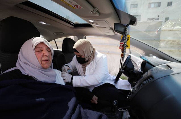 (210404) -- NABLUS, April 4, 2021 -- A woman receives a dose of Sinopharm COVID-19 vaccine during a vaccination campaign in the West Bank city of Nablus, April 4, 2021. China on March 29 handed over a batch of donated Sinopharm COVID-19 vaccines to Palestine to support its nationwide fight against the pandemic. (Photo by Xinhua) MIDEAST-NABLUS-SINOPHARM-COVID-19-VACCINATION AymanxNobani 