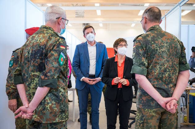 The vaccination center of the German Federal Armed Forces starts the around the clock vaccination enterprise The Federal Minister of Defense Annegret Kramp Karrenbauer red blouse gives together with Prime Minister Tobias Hans blue suit and Health Minister Monika Bachmann blazer pink on Easter Sunday 04 04 2021 the starting signal for the extended operating times in the bub