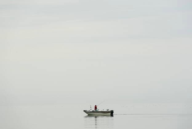 April 5, 2021, Toronto, on, Canada: A fisherman trolls a calm Lake Ontario near Humber Bay during the COVID-19 pandemic in Toronto on Monday, April 5, 2021. Toronto Canada  - ZUMAc35_ 20210405_zaf_c35_033 Copyright: xNathanxDenettex